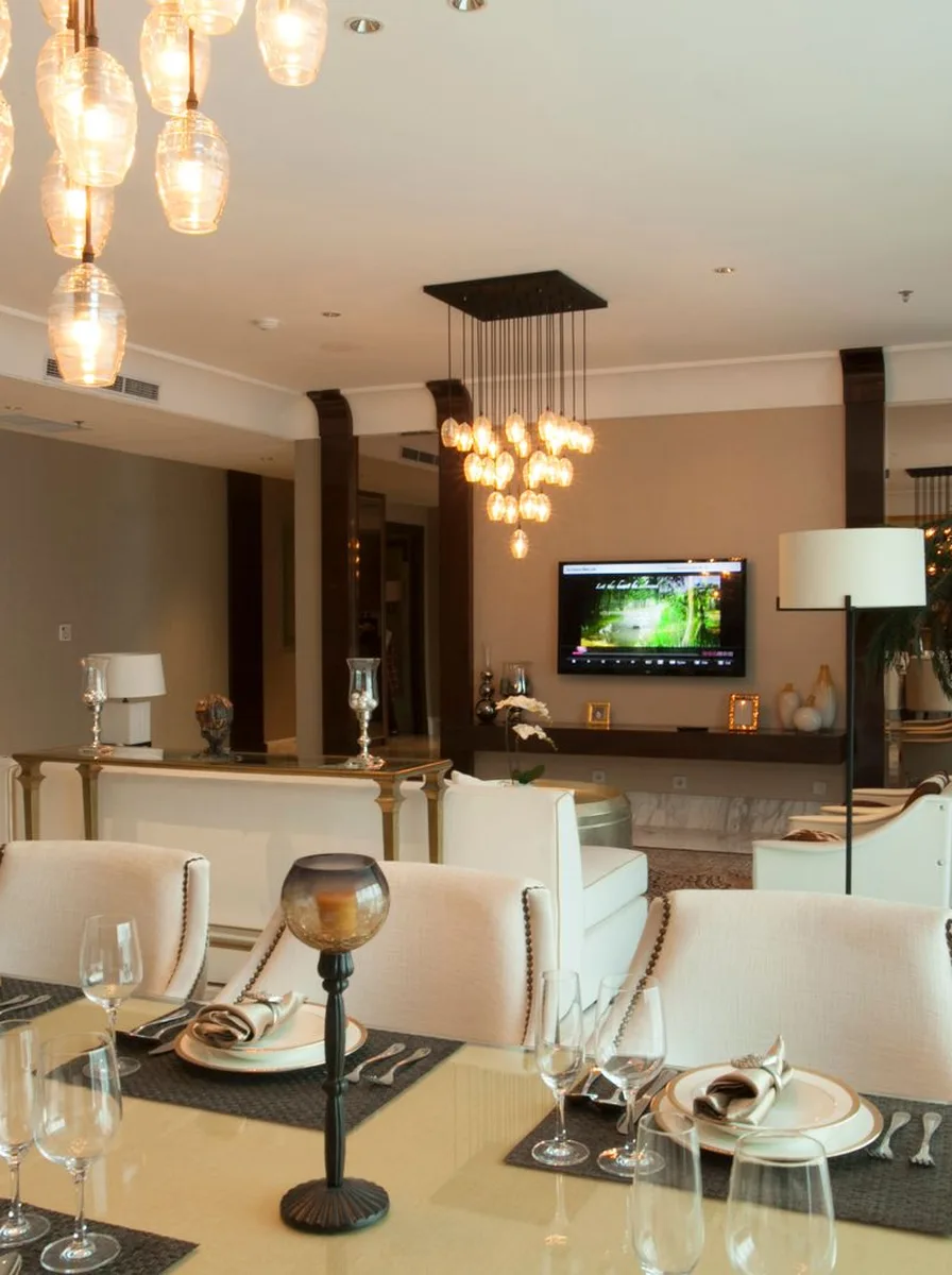 Luxury dining room with cascading gold globe pendant lights over a white table