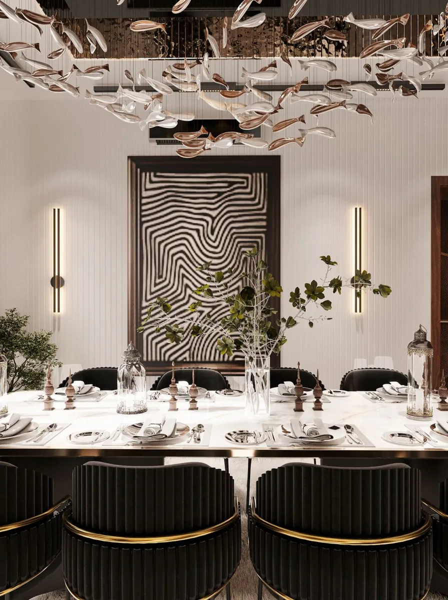 Monochrome dining room with sculptural ceiling art and a graphic wall panel