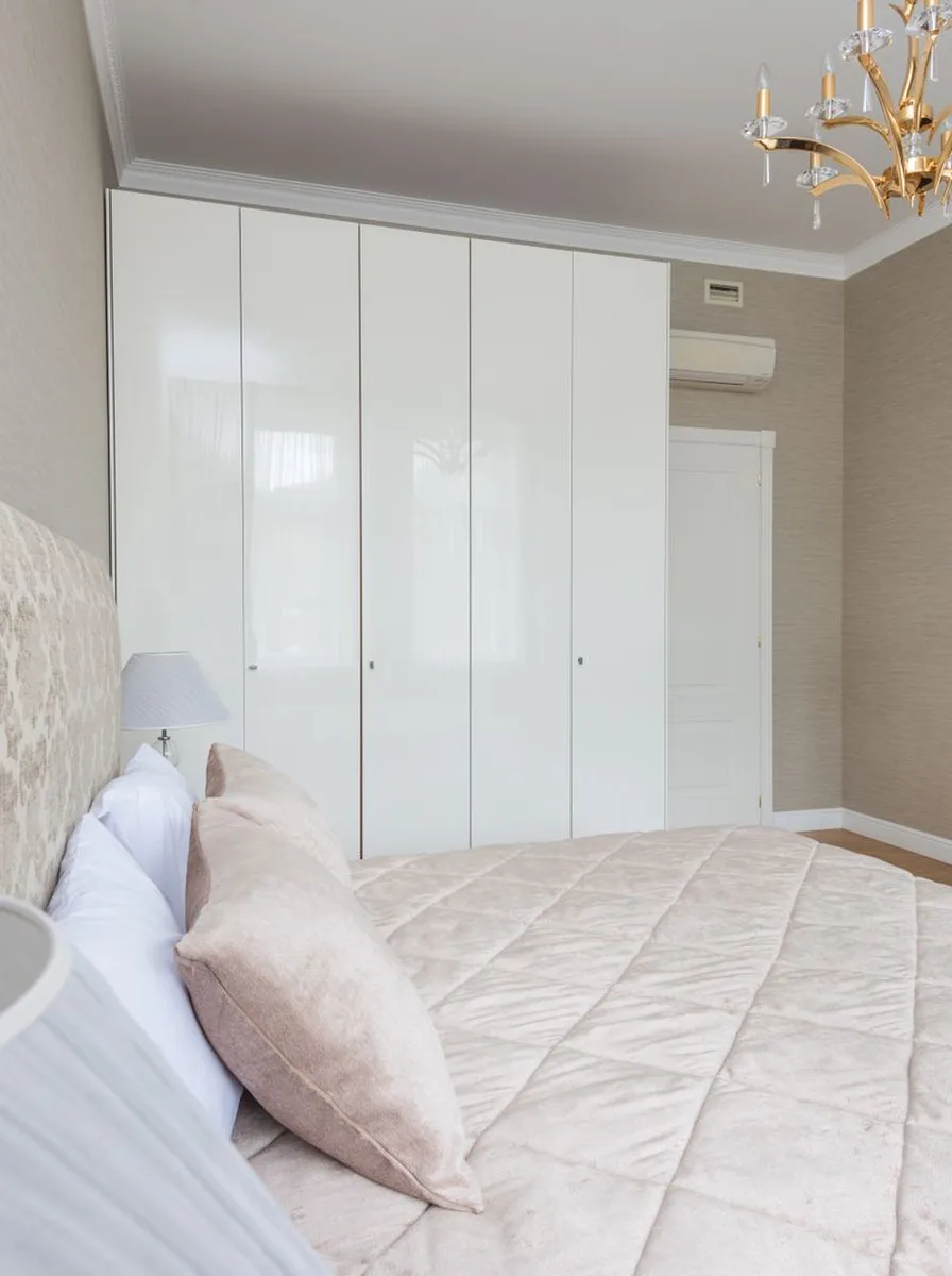 Blush bedroom with white wardrobe