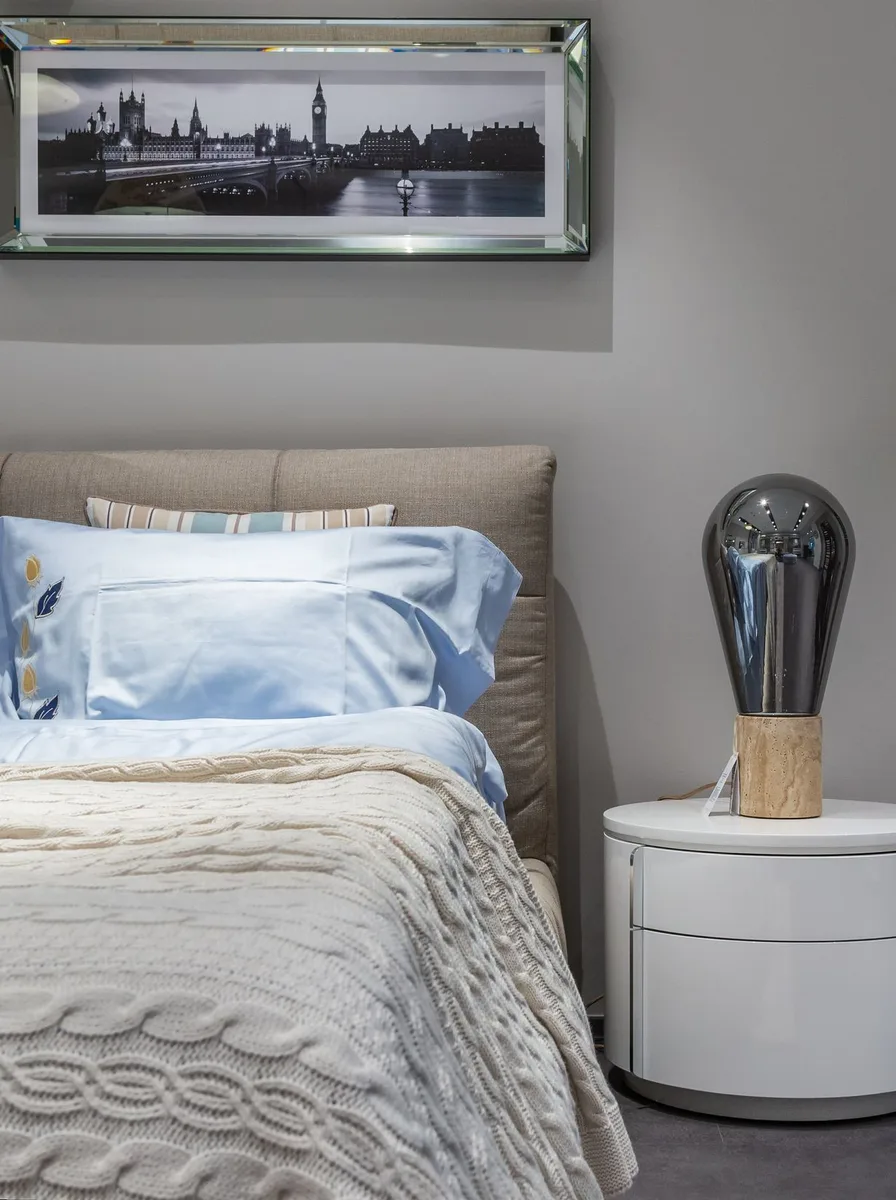 Grey bedroom with cityscape art