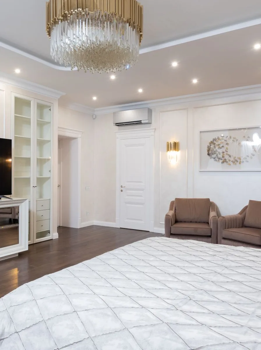 White bedroom with crystal chandelier