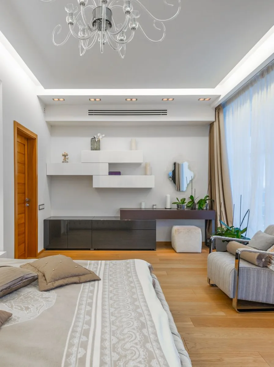 Neutral bedroom with desk and beige bedding