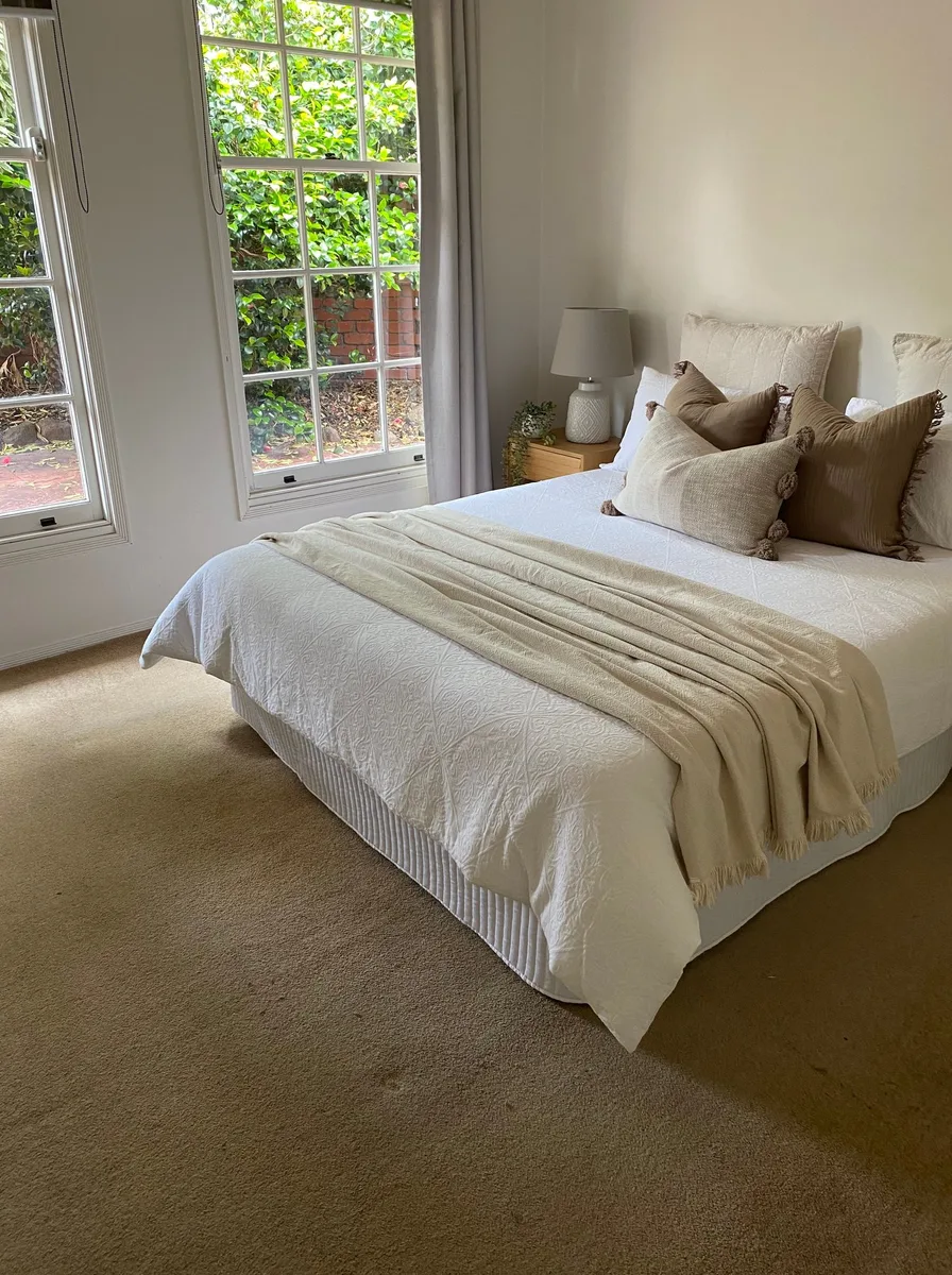 Cream bedroom with garden view windows