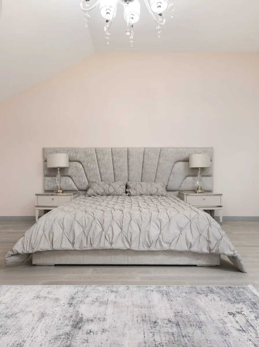 Beige patterned bedroom with chandelier