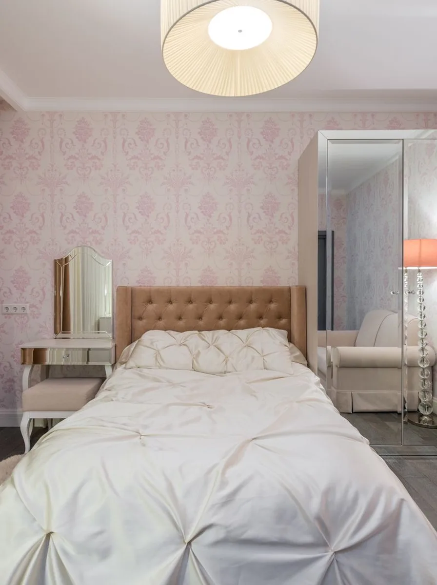 White bedroom with vanity and pink wallpaper