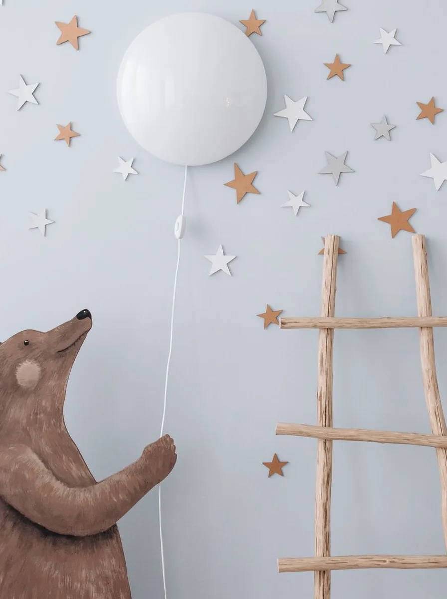 Nursery with creative two-tone wall in sage green and white