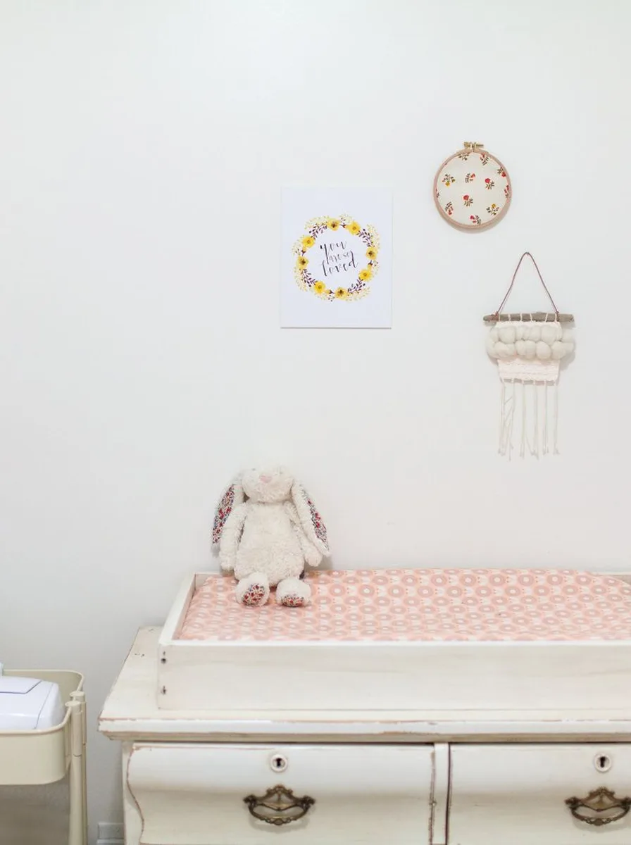 Sage green nursery with cream walls and natural wood accents