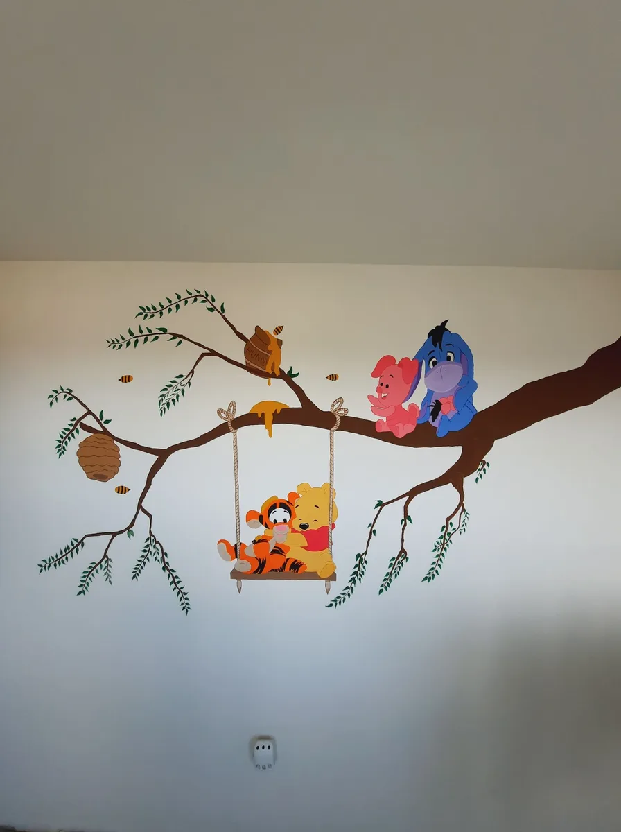Nursery wall with applied animal wall decals around the crib area