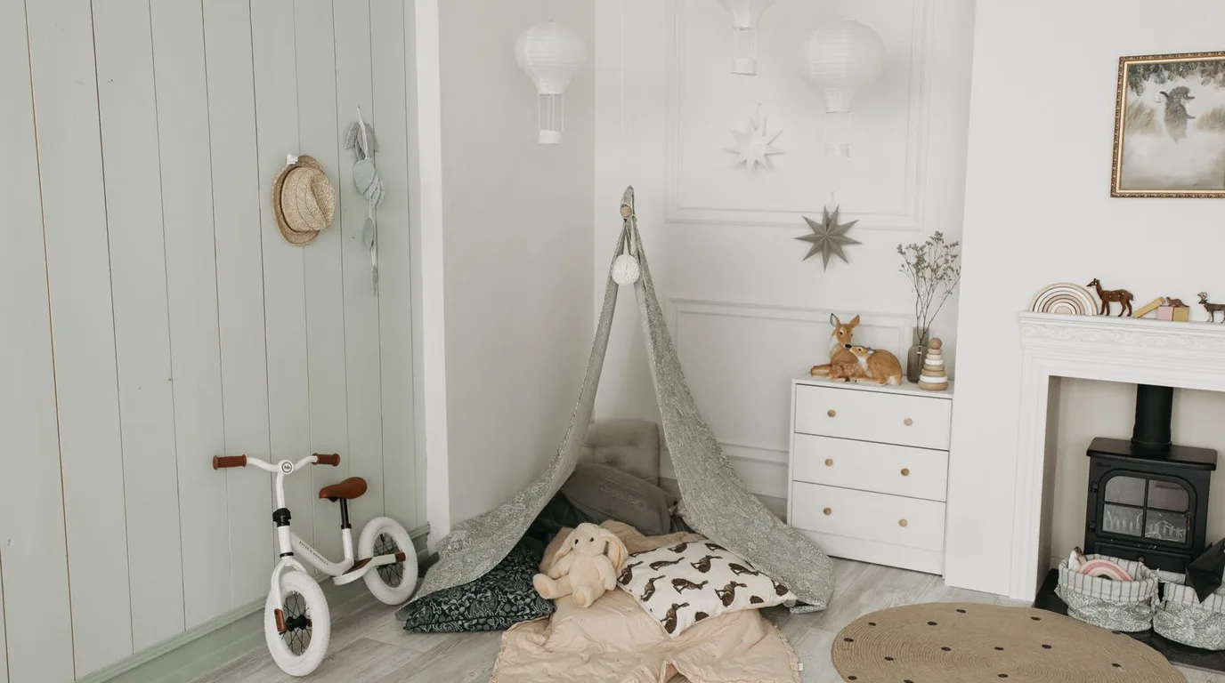 Small nursery room with mini crib, light walls, and clever compact layout