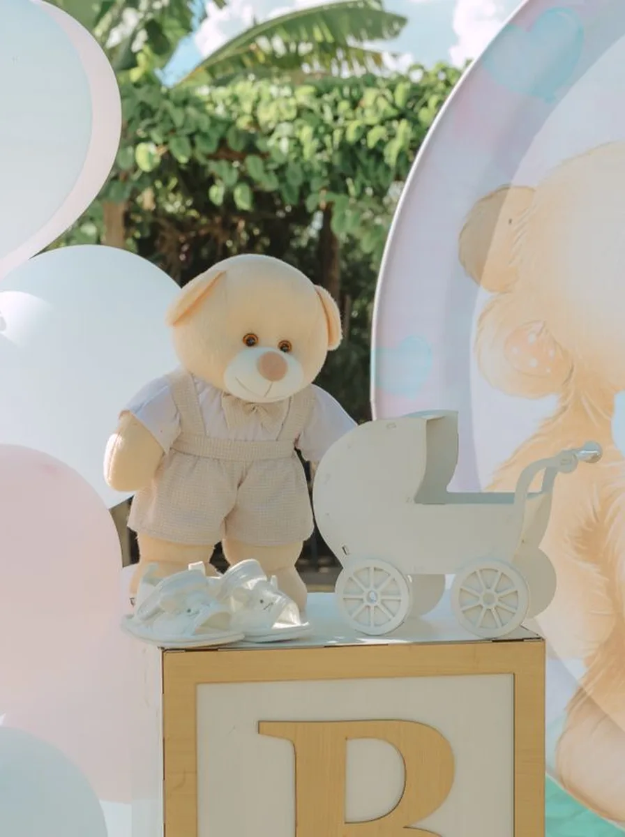 Teddy bear with a pram and wooden blocks