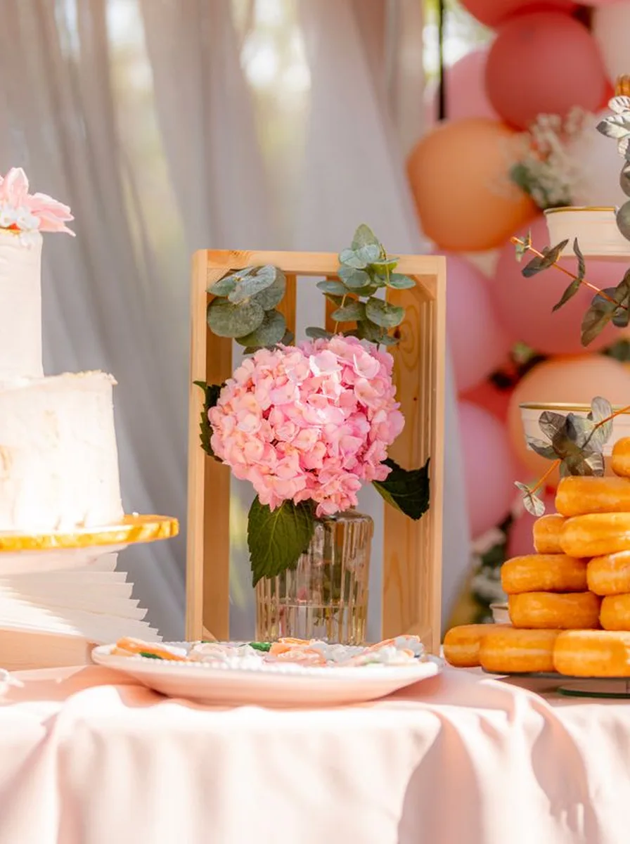 Pink party table with baby shower treats
