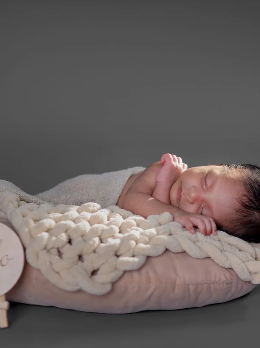 Sleeping baby on a knit pillow