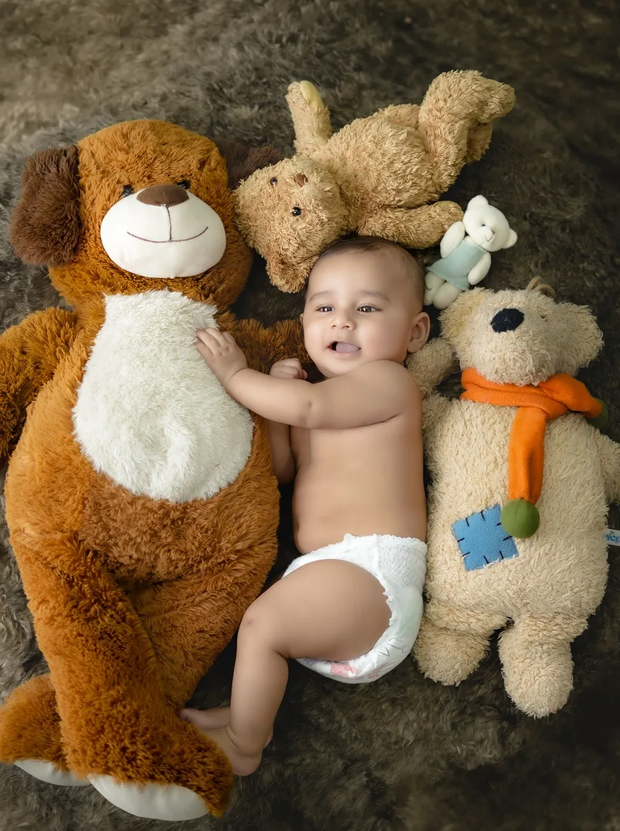 Baby sitting with teddy bears