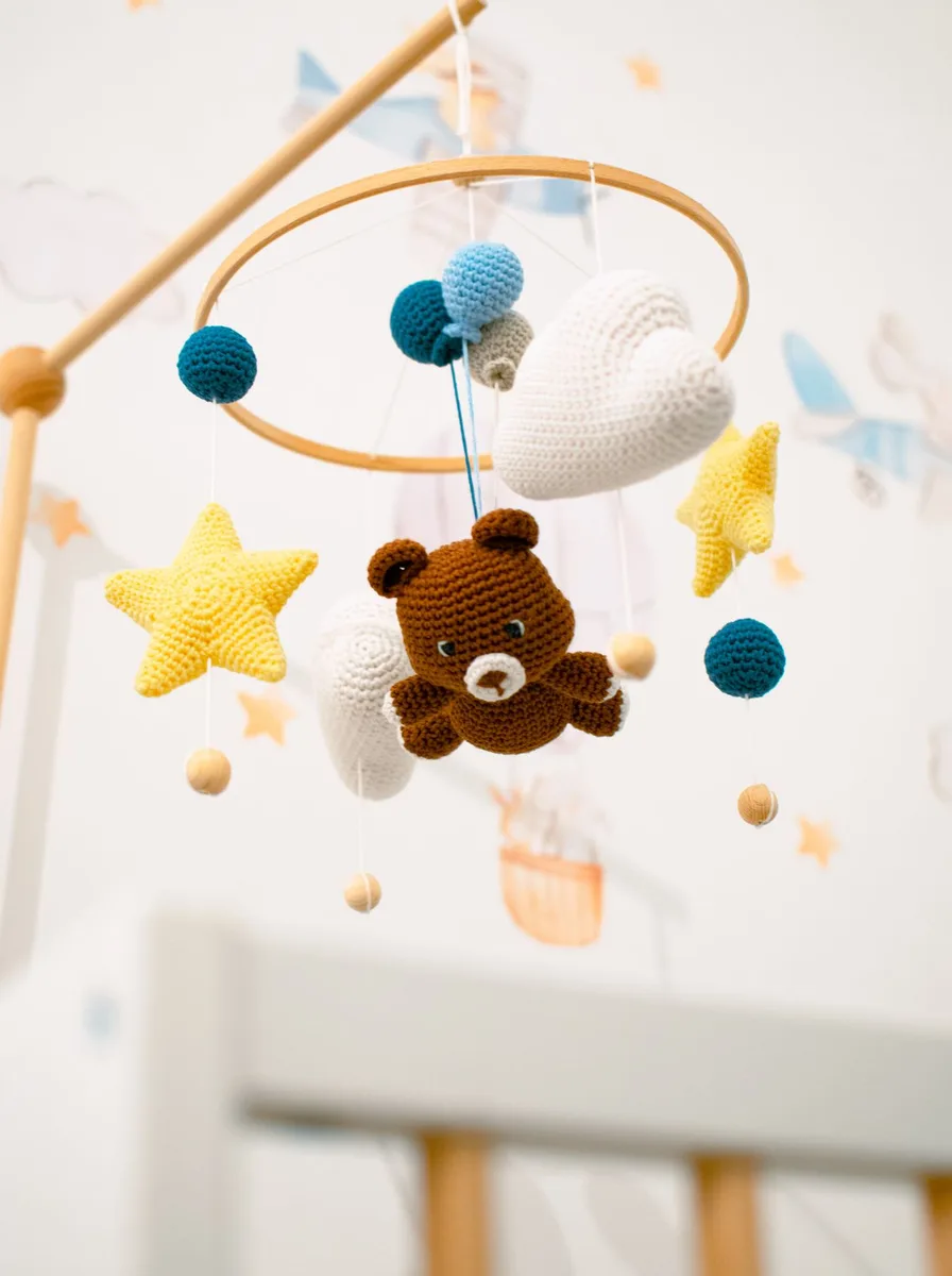 Star and bear crib mobile hanging in a nursery