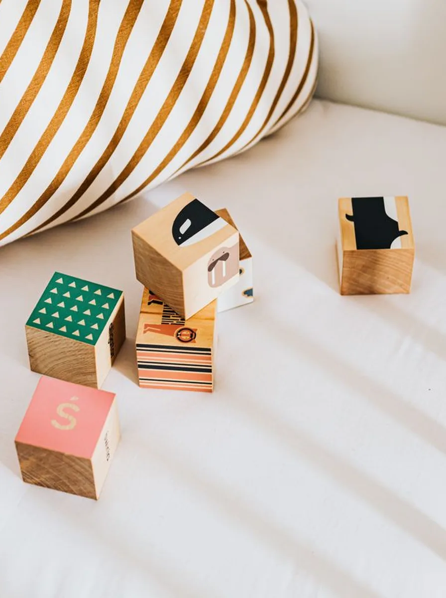 Wooden blocks on a white bed