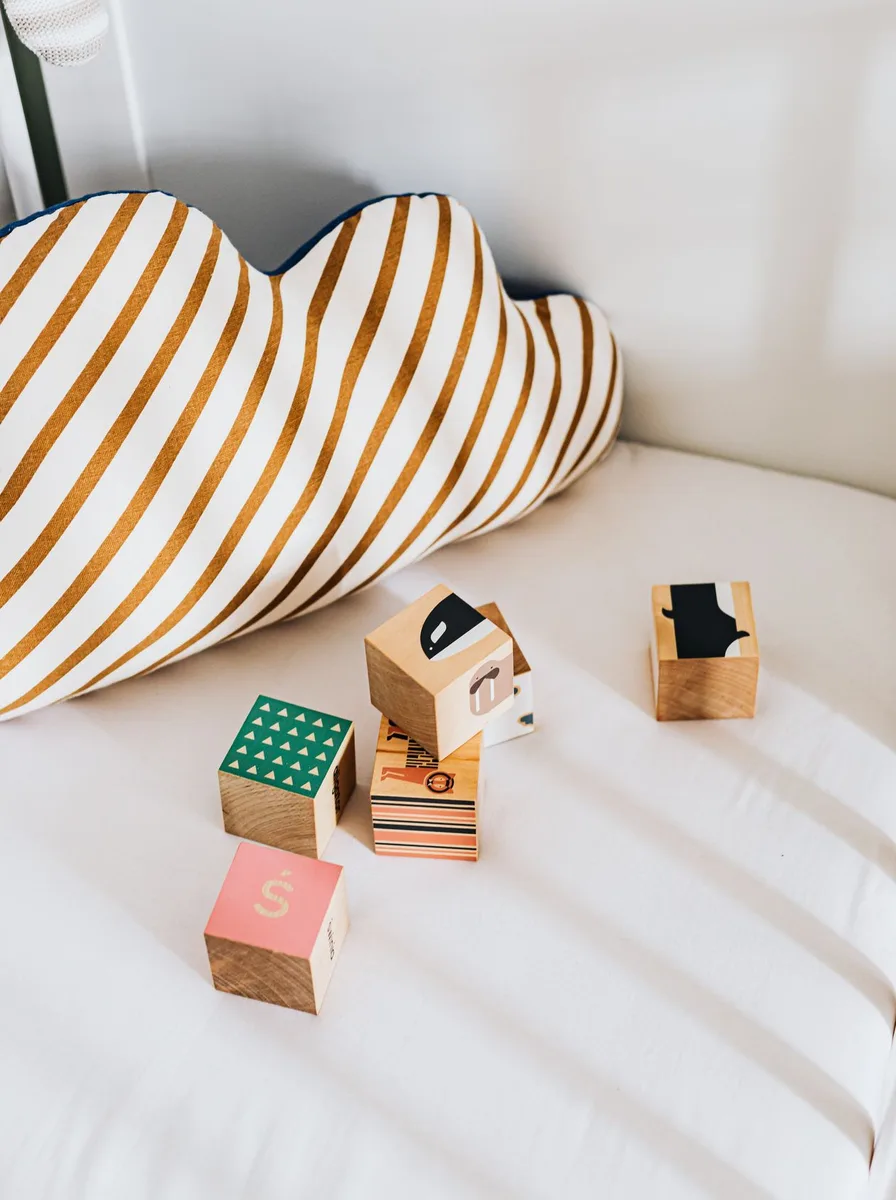 Wooden blocks with a striped pillow