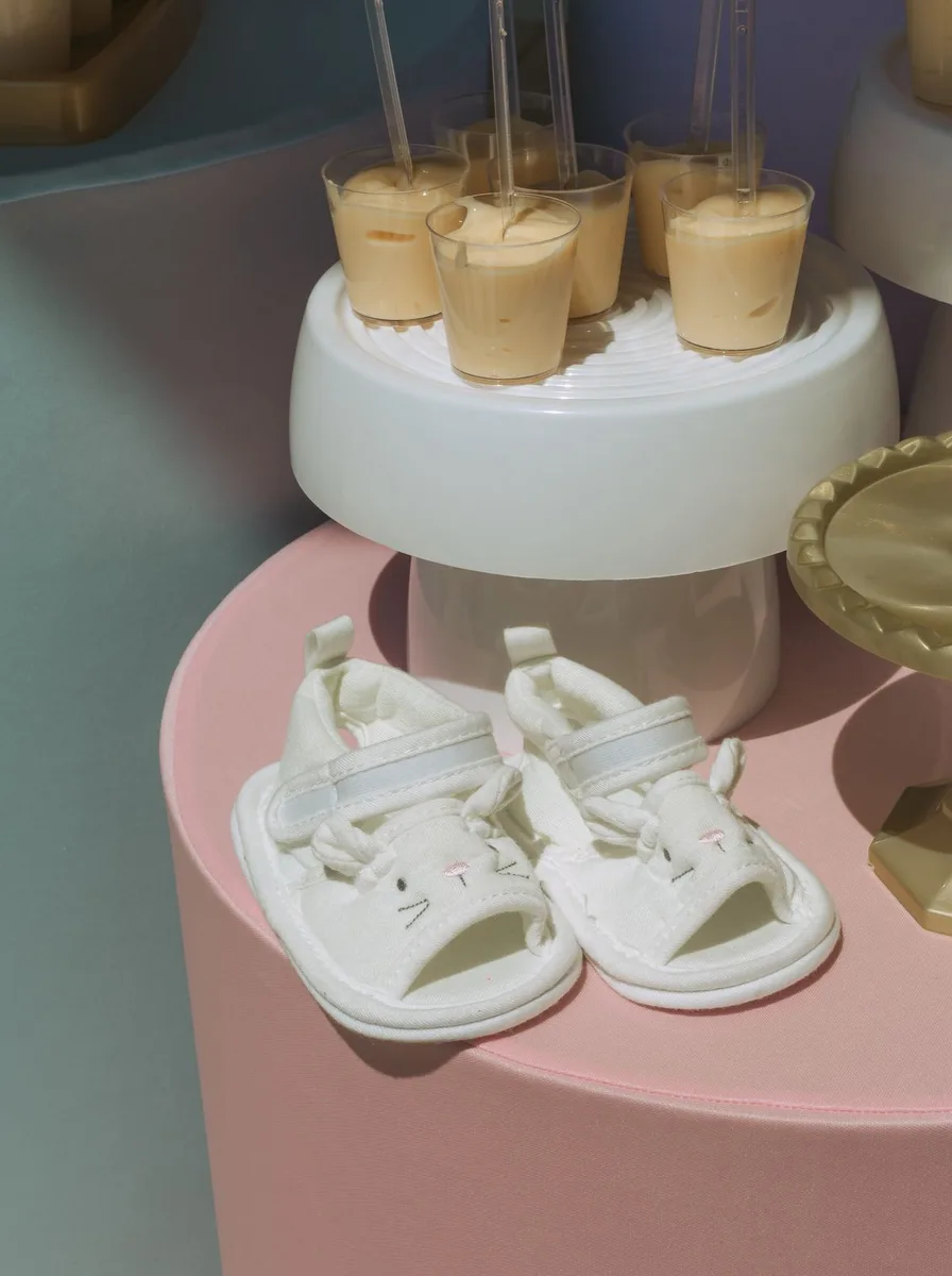 Baby shoes displayed on a nursery stand