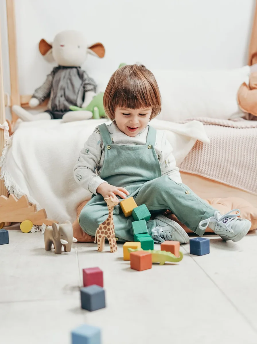 Toddler playing with colourful blocks
