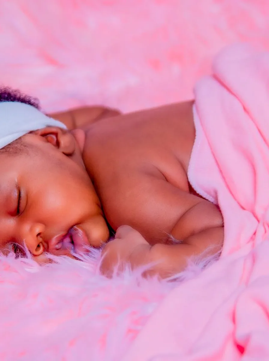 Sleeping baby on a pink fluffy blanket