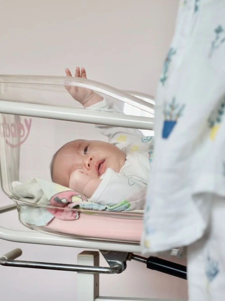 White wooden crib as the centrepiece of a nursery