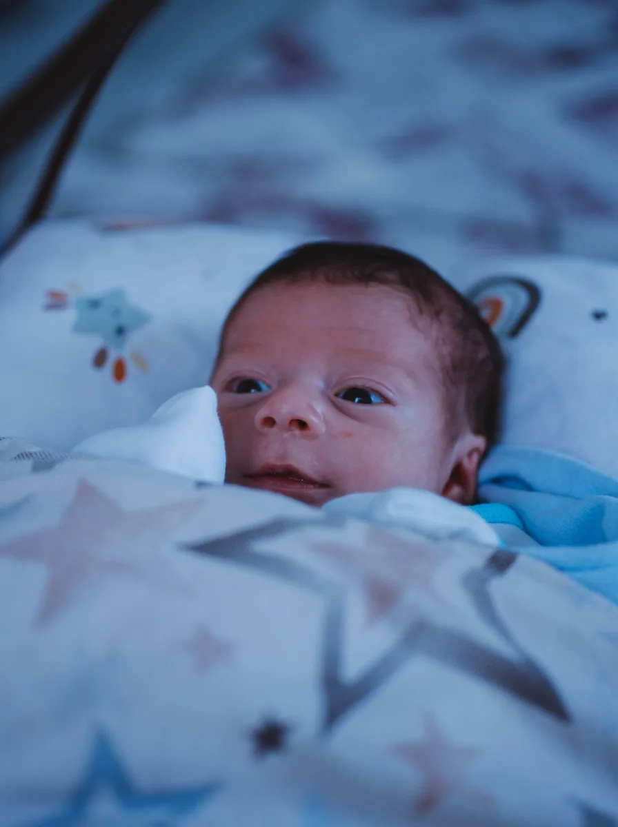 Newborn baby in star-print bedding