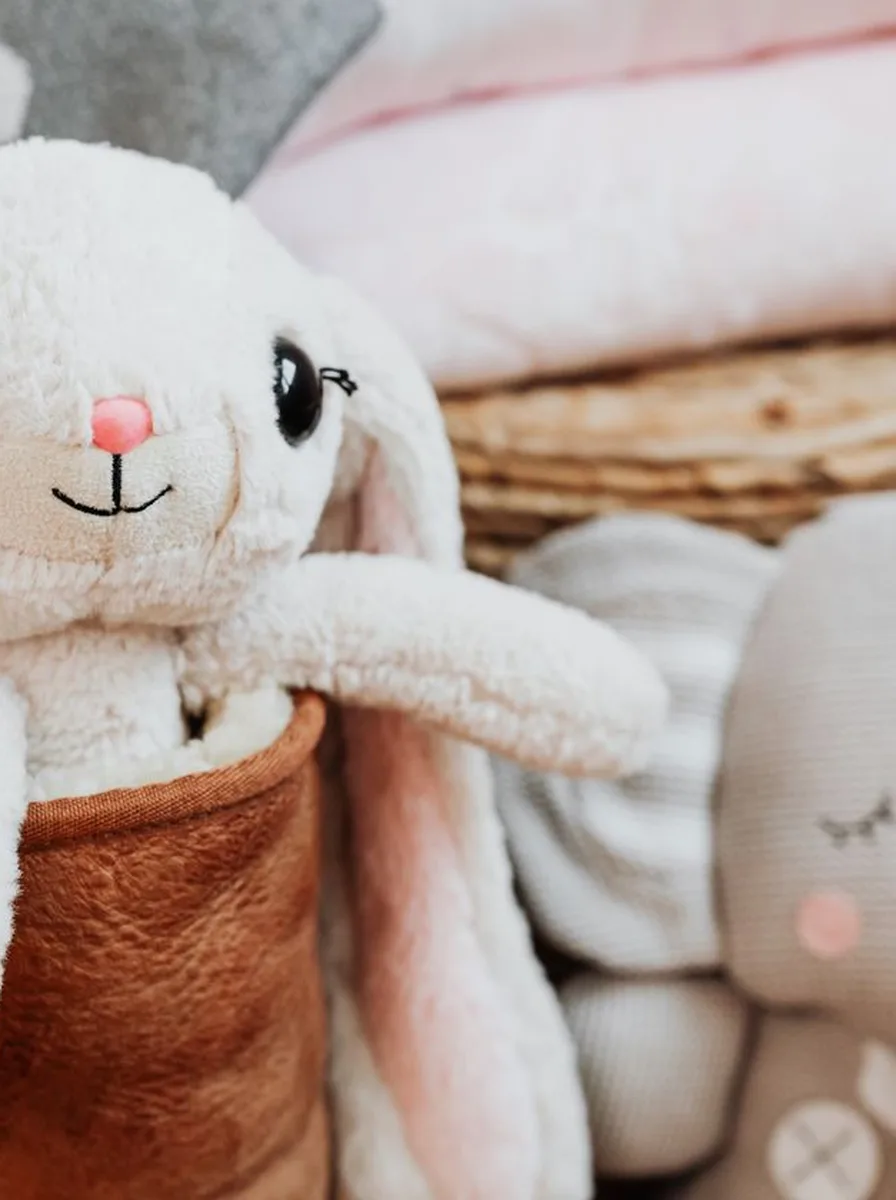 White bunny plush on a bed