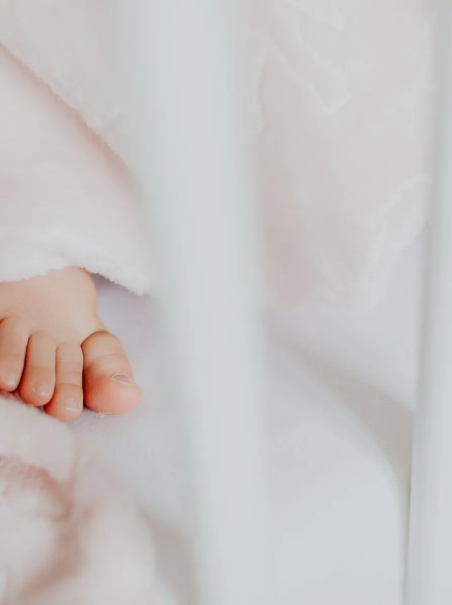 Close-up of baby feet on white