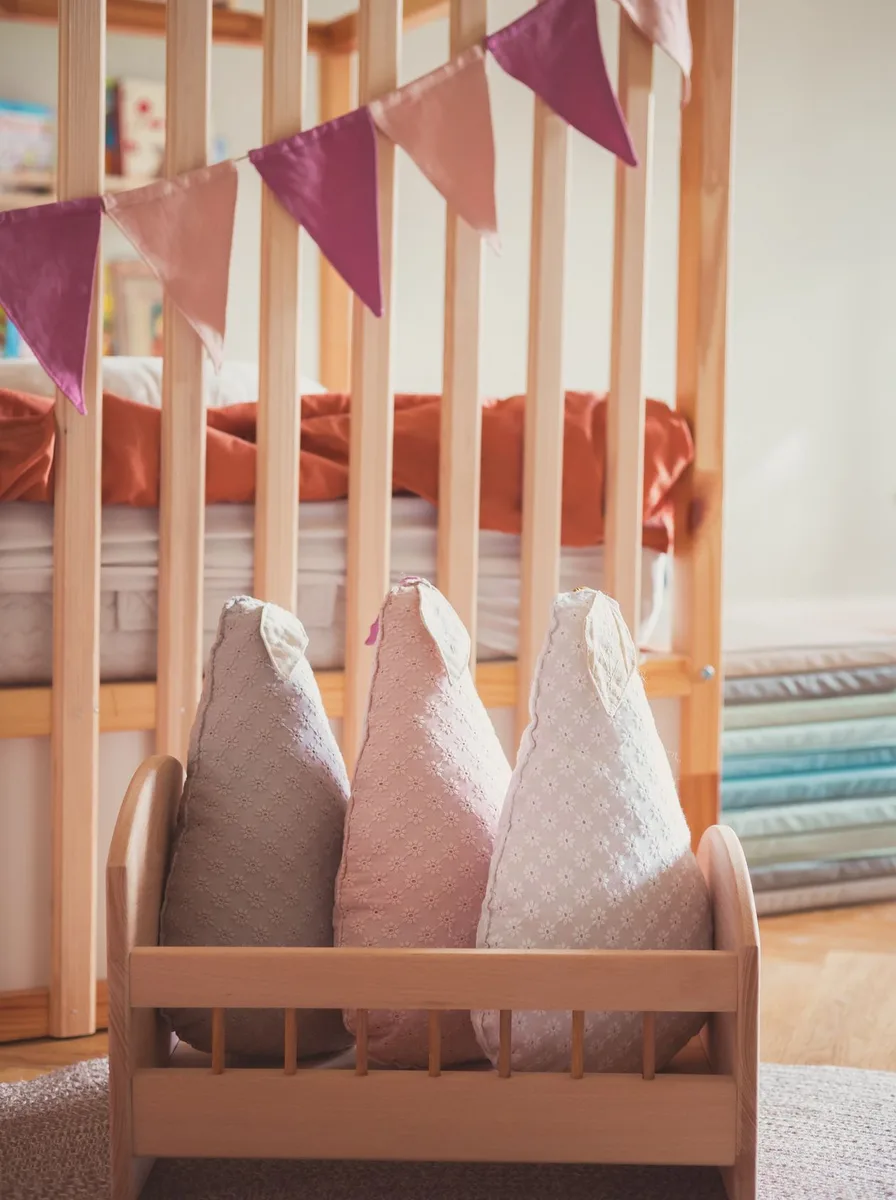 Wooden doll crib with colourful bunting