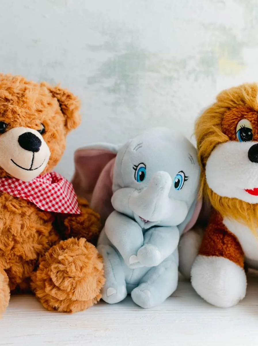 Plush safari animals on a nursery shelf
