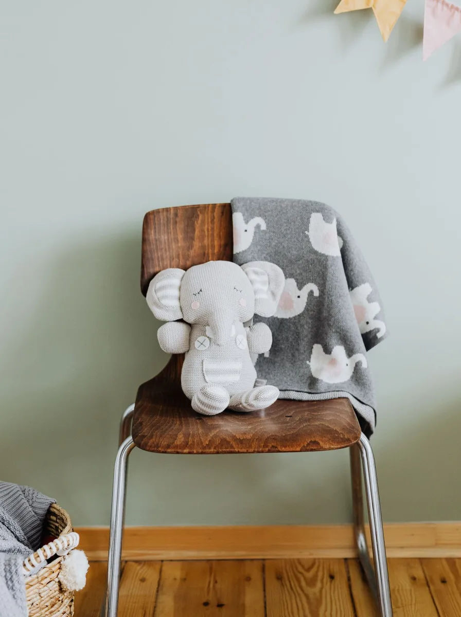 Elephant plush on a wooden chair
