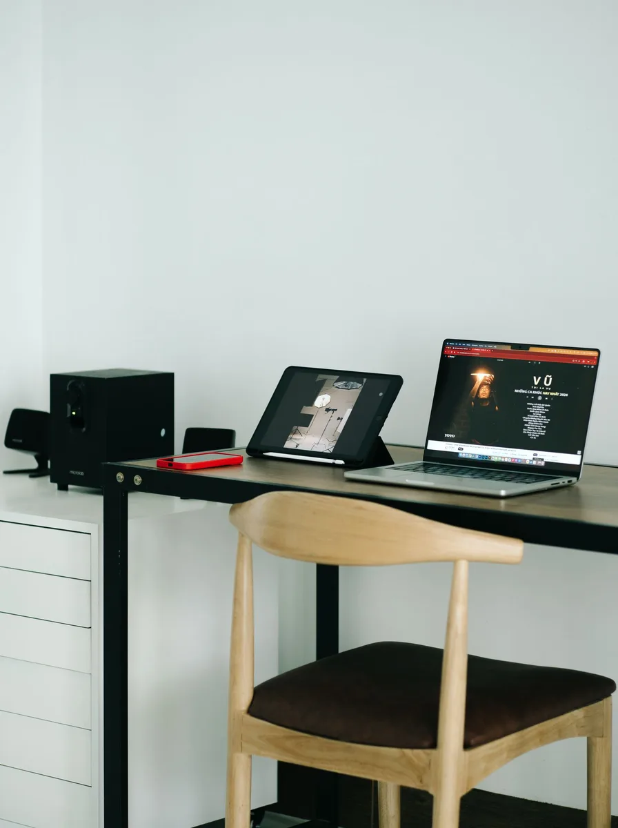Office chair armrests adjusted to support elbows at desk height