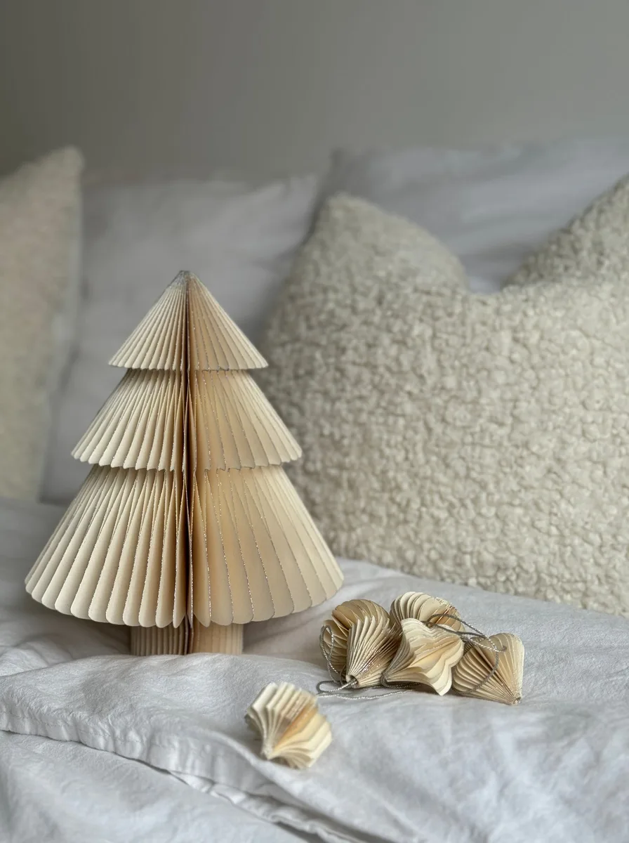 Paper Christmas tree decoration on a bed