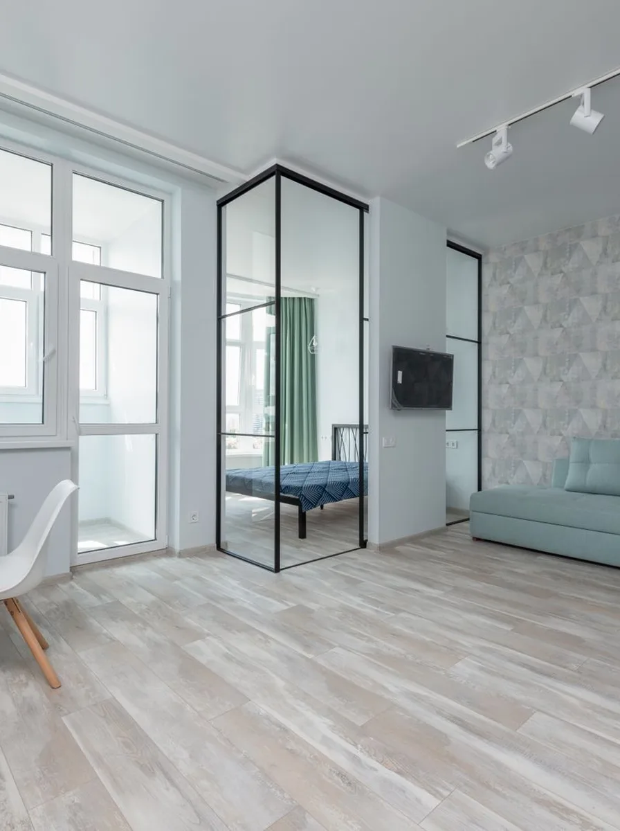 Floor-to-ceiling bookshelves maximizing vertical storage in tiny room