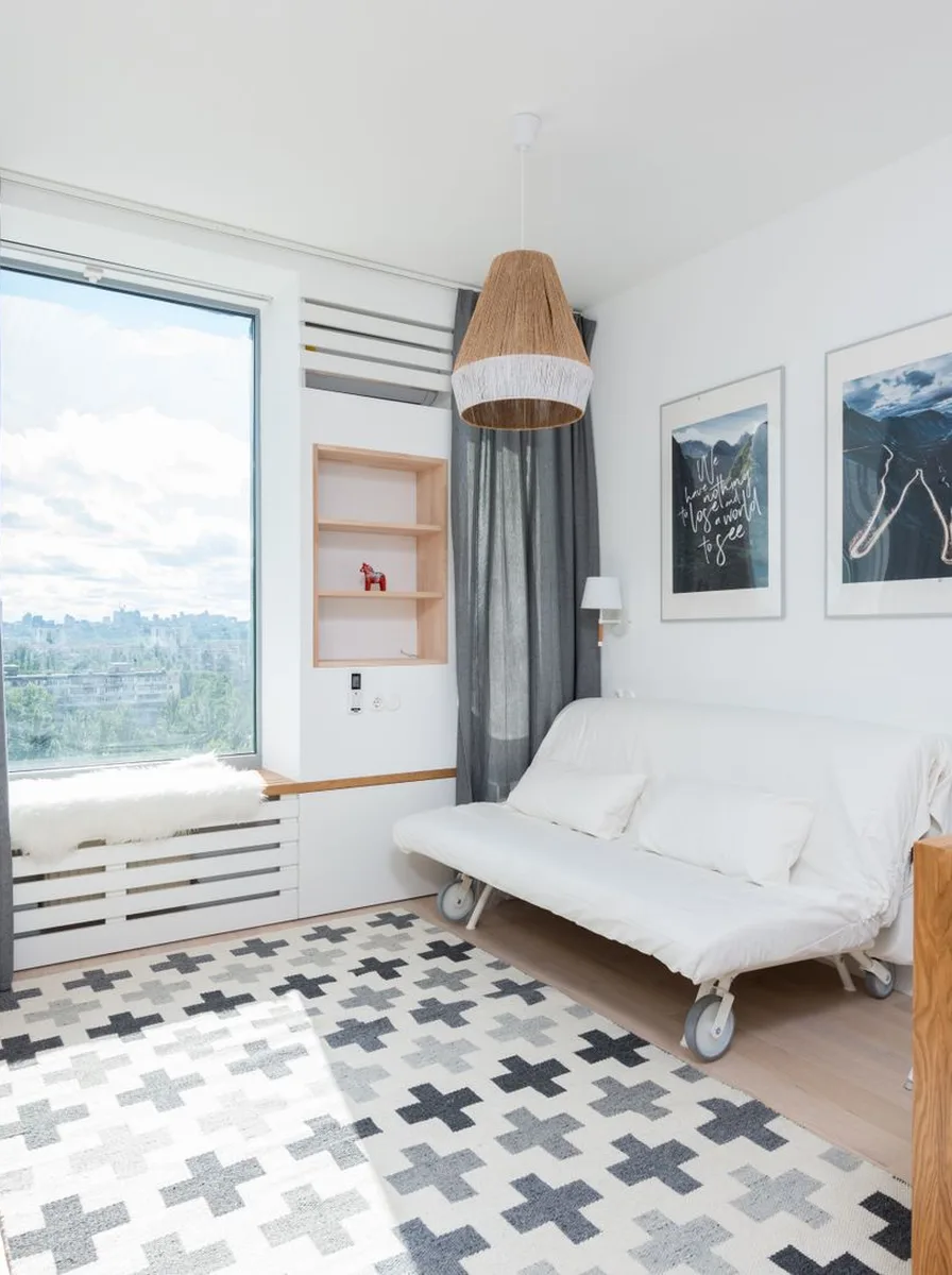 Large mirror opposite window doubling light in tiny room