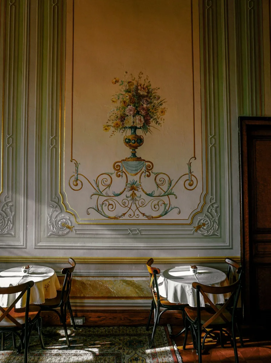 Elegant dining room with a hand-painted floral mural on the wall panel