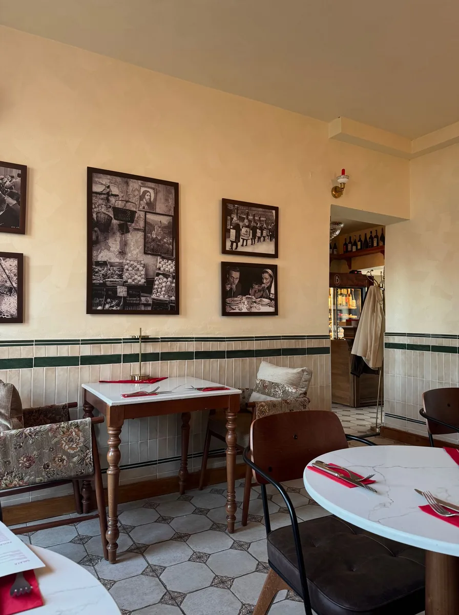 Vintage cafe dining room with black-and-white photos in a bistro row