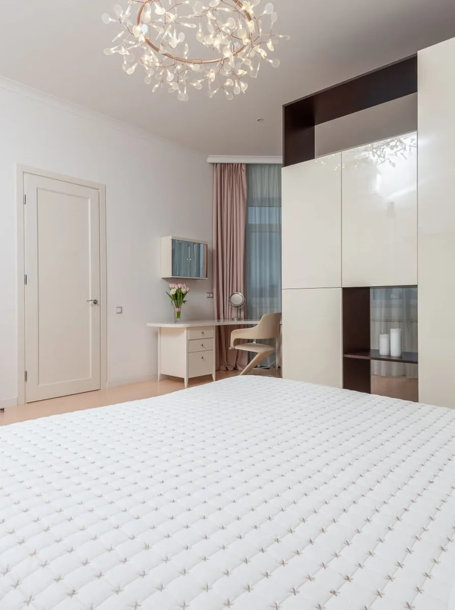 Small bedroom with light wood floor and white bedding