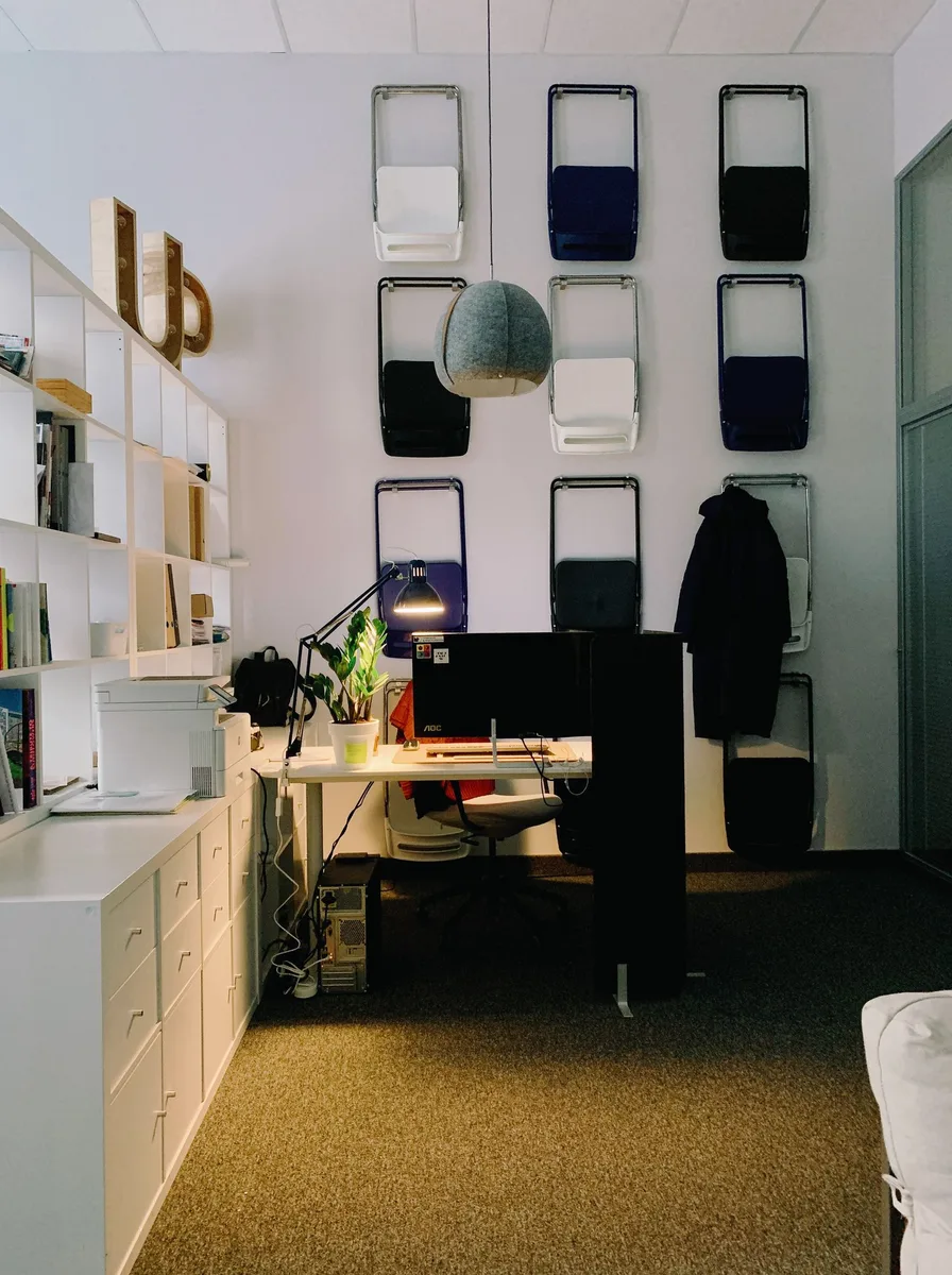 Armless compact desk chair slid under a small white desk