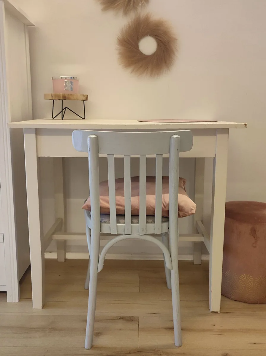 Small upholstered desk chair with proper seat cushion in a studio flat