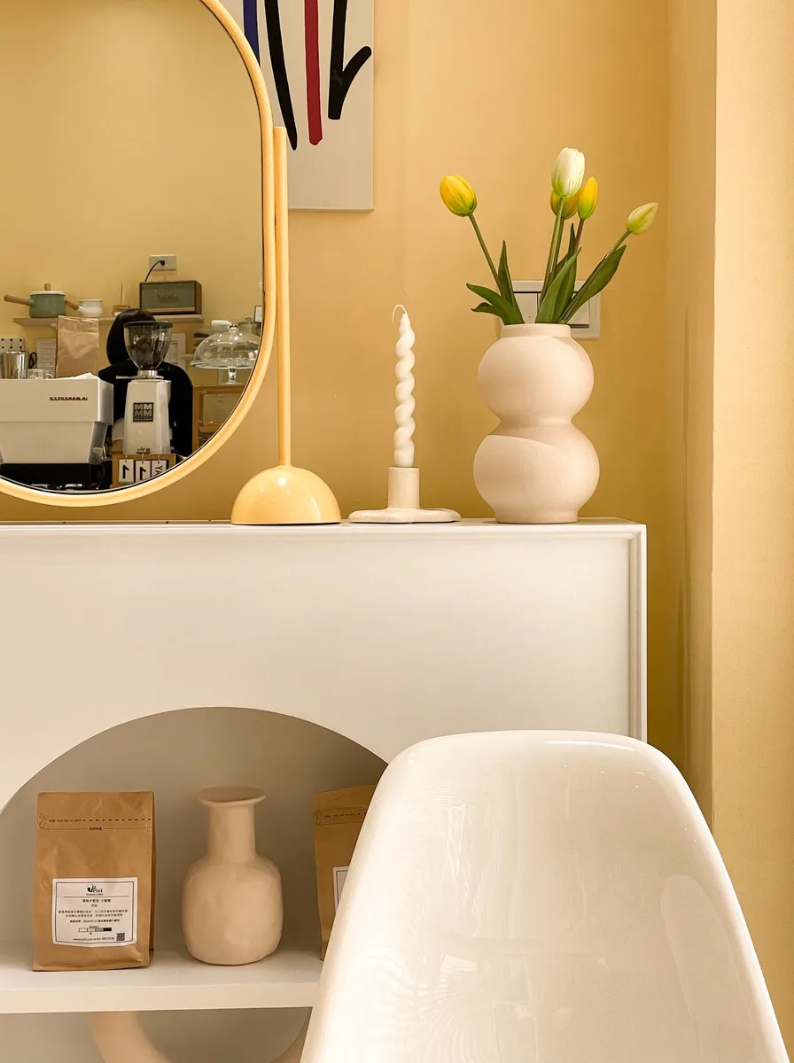 Compact bedroom with art and mirrors aligned at eye level