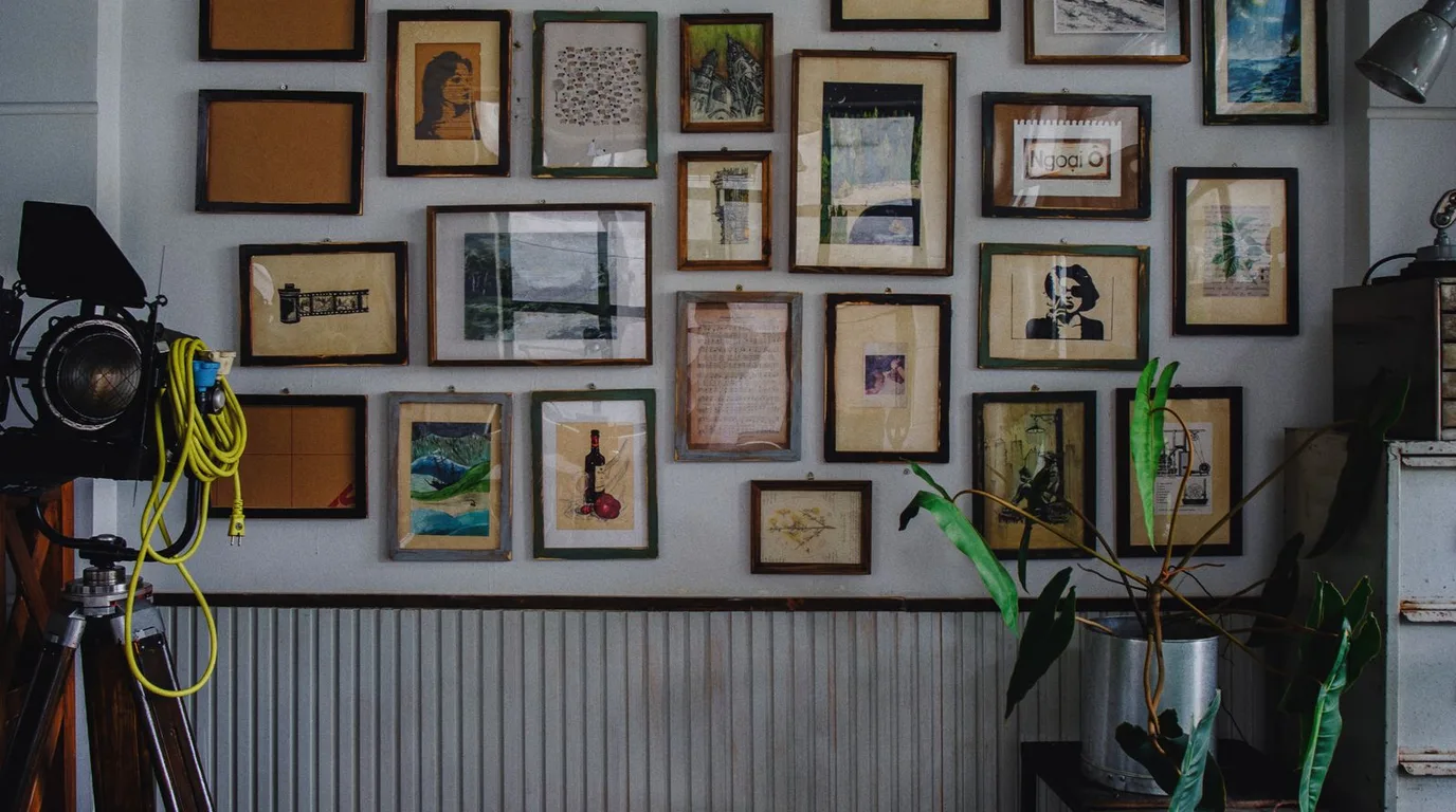 Gallery wall of many small framed pictures and prints
