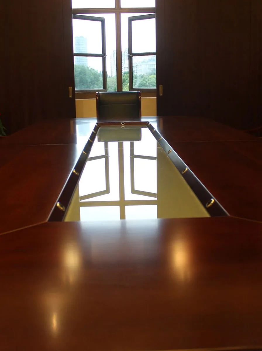 Desk chair tucked under a wooden desk