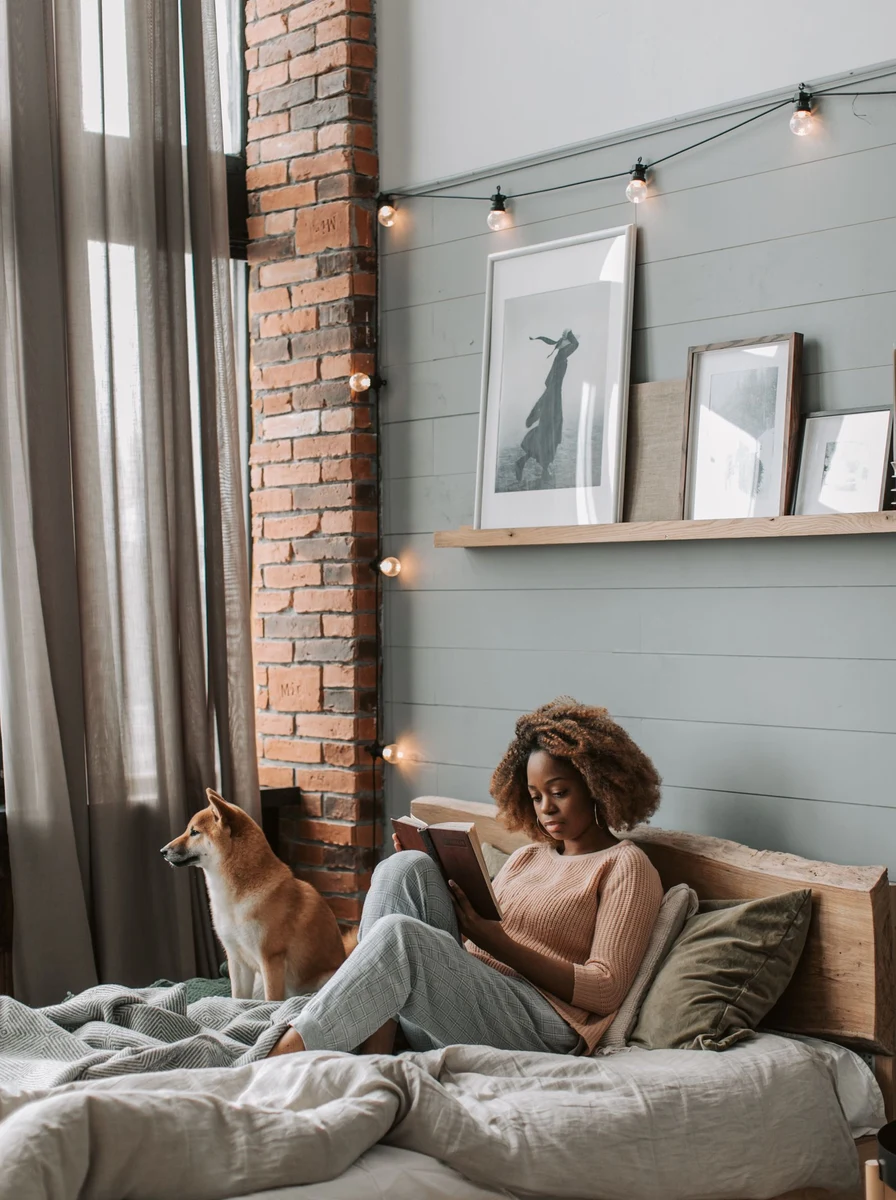 Reading nook with armchair blanket and floor lamp in a teen bedroom
