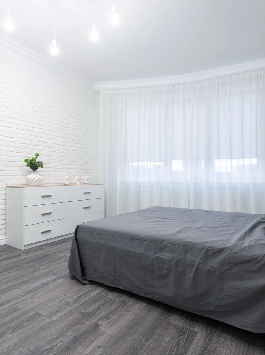 Wooden tray corralling items on bedroom nightstand