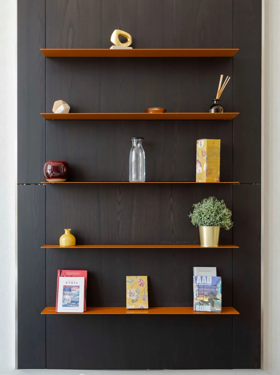 Hanging fabric shelves holding folded sweaters