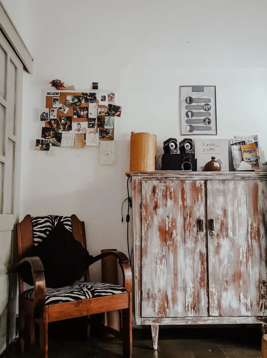 Thrifted picture frames spray-painted gold on wall