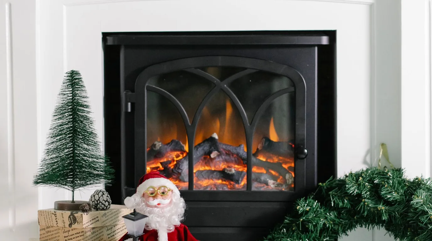 White fireplace with Santa, Christmas tree, and gifts