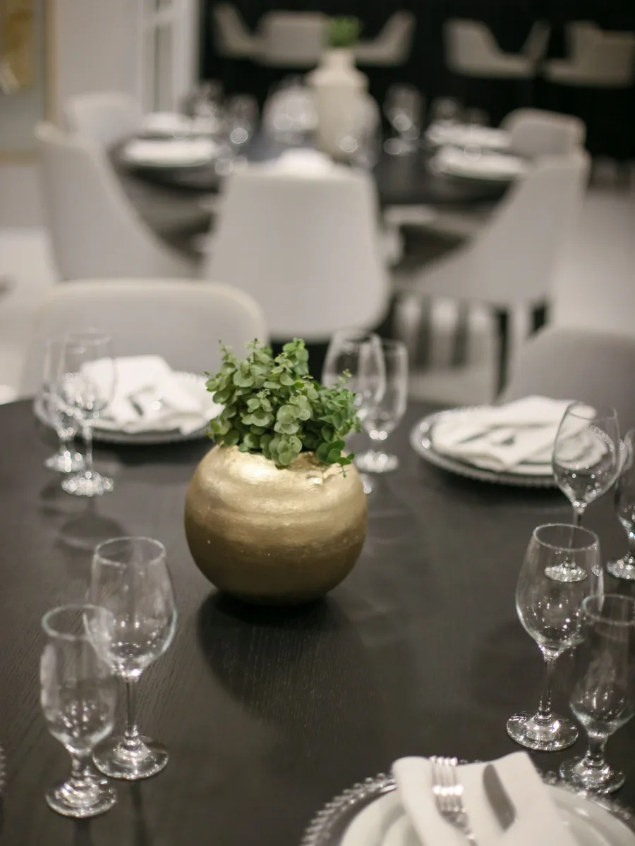 Cluster of candles with eucalyptus sprigs on a dining table