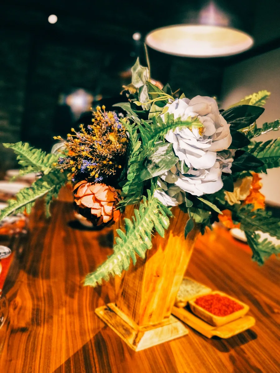 Gold geometric terrarium with succulents on a dining table