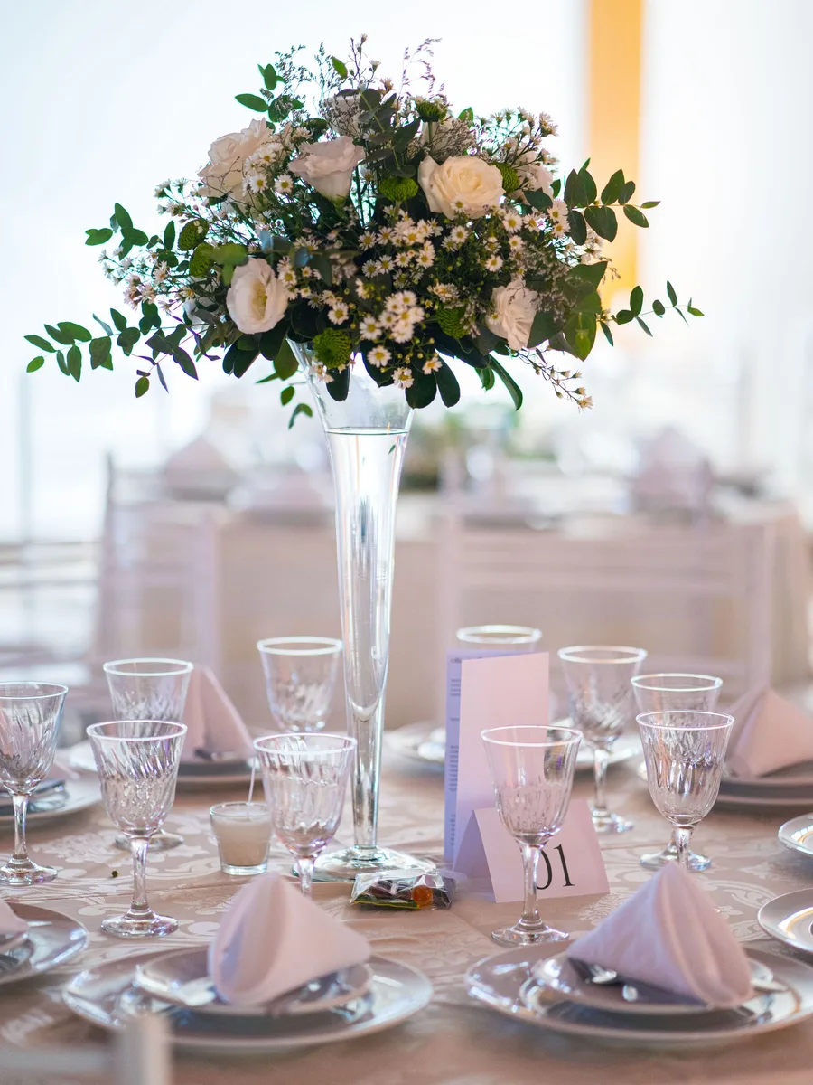 Silver candelabra with lit tapers on a dining table